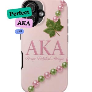 May include: A light pink phone case featuring the text "AKA" and "Pretty Polished Always" in pink lettering. The design includes a green ivy leaf and a string of alternating pink and green pearls. The text "Perfect", "AKA", and "GIFT" appears.