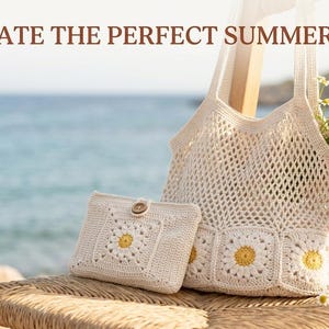 May include: A cream-colored crochet tote bag and a matching rectangular pouch, both featuring white and yellow daisy motifs. The text "CREATE THE PERFECT SUMMER SET" is displayed at the top of the image above the bags.