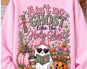 May include: A light pink crewneck sweatshirt featuring a graphic print with the text "Ain't no GHOST like the Holy Ghost". The design includes a ghost wearing heart-shaped sunglasses and a bow, pumpkins, flowers, and a stack of books labeled PRAY, READ, BE STILL.
