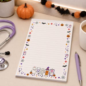 May include: A rectangular notepad with horizontal lines and a border featuring Halloween-themed medical icons including pumpkins, bats, stethoscopes, and spiders. At the bottom, cartoon characters include a ghost, stethoscope, mummy, and clipboard.