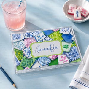 May include: A rectangular clear acrylic tray featuring a colorful collage of blue, green, and pink patterned tiles. A central lime green label with a decorative border displays the name Jennifer in blue cursive script across the center.