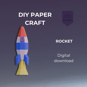 Op de afbeelding: Een kleurrijke DIY papieren raket met rode, witte en blauwe secties en gele vlammen. De afbeelding bevat de tekst "DIY PAPER CRAFT", "ROCKET" en "Digital download". Een Techpoly-logo staat in de rechterbovenhoek.