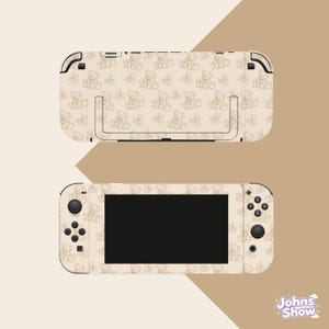 May include: A beige gaming console skin featuring a repeating pattern of brown line-art teddy bears. The skin covers the front of the console, including the controllers with black buttons and joysticks, and the back panel with a kickstand cutout.