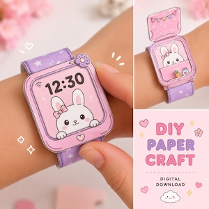 May include: A paper craft watch featuring a purple strap with white stars and a pink face displaying a white rabbit with a bow, the time 12:30, and a small flower accent. The design includes a flip-top cover and a digital download label.