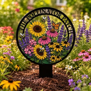 May include: A circular black metal garden stake featuring the text THE POLLINATOR PATCH along the top edge. The design includes colorful illustrations of sunflowers, purple coneflowers, lavender, bees, and a monarch butterfly on a green background.