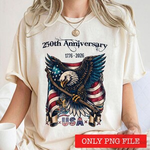 May include: Cream-coloured t-shirt with a patriotic design for the 250th anniversary of the USA. The graphic includes an eagle, the American flag, and the text "250th Anniversary 1776-2026 USA".