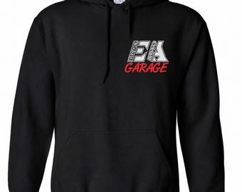 May include: A black hooded sweatshirt featuring a front kangaroo pocket and long sleeves. The chest displays a white graphic logo with the text EVERYTHING AUTO and the word GARAGE printed in red underneath the logo.