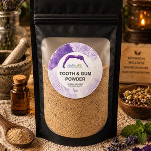 May include: A black stand-up pouch containing light brown tooth and gum powder. The circular label features a purple watercolor design, a silhouette of a person stretching, and the text HAPI-LIFE: TOOTH & GUM POWDER HERBAL WELLNESS FOR ORAL HEALTH.