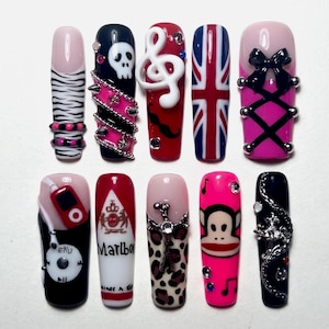 May include: A set of ten press-on nails featuring diverse designs including zebra print, a skull with pink chains, a white treble clef, a British flag, a black corset bow, an MP3 player, a Marlboro logo, leopard print, a monkey, and silver chains.