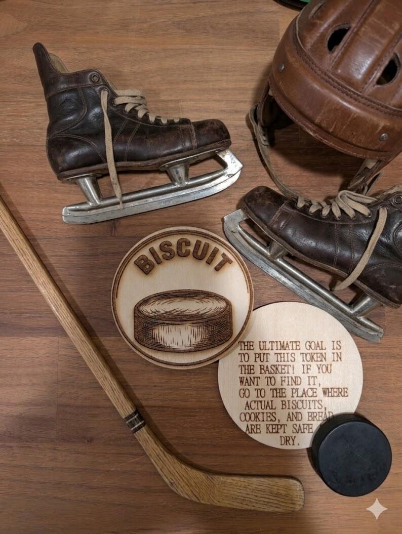 May include: A pair of vintage brown leather ice skates, a brown leather hockey helmet, a wooden hockey stick, a black hockey puck, and two circular wooden plaques. One plaque features a hockey puck and the word BISCUIT, while the other has text.