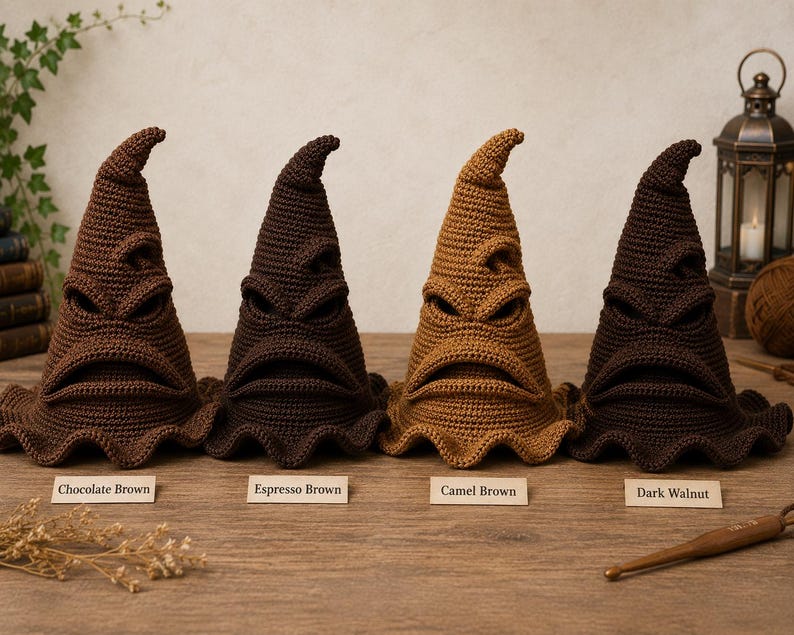 May include: Four crocheted pointed hats with expressive facial features including eyes and a mouth. The hats are labeled Chocolate Brown, Espresso Brown, Camel Brown, and Dark Walnut, showcasing different shades of brown yarn in a textured stitch.