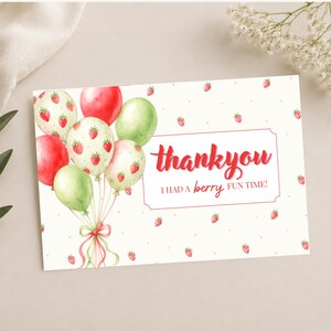 May include: A thank you card with a watercolor design. The card features a cluster of balloons in red, green, and white, some adorned with strawberry patterns. The text "thank you" is in red script, with "I had a berry fun time!" below.