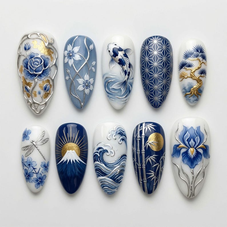 May include: A set of ten almond-shaped press-on nails featuring intricate blue, white, and gold designs. Patterns include a rose, cherry blossoms, a koi fish, geometric lines, a bonsai tree, a dragonfly, Mount Fuji, ocean waves, bamboo, and an iris.