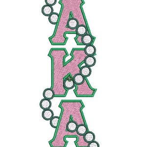 May include: An embroidery design featuring the letters AKA stacked vertically. The letters are filled with a light pink thread and outlined in a dark green border. A string of white circular pearls with dark green outlines weaves through the letters.