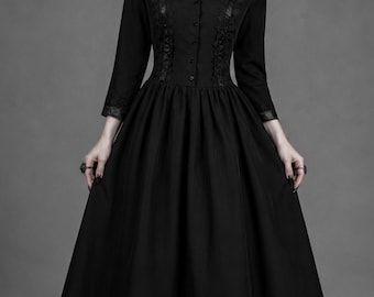 May include: A long black dress with a high collar and long sleeves. The dress features decorative lace detailing on the bodice and sleeves. The skirt is full and flowing, creating a dramatic silhouette. The dress is suitable for gothic or formal occasions.