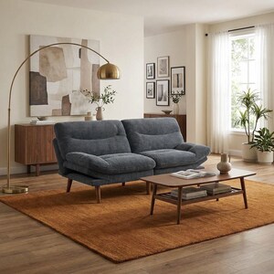 May include: A living room with a blue corduroy sofa, wooden coffee table, and a rust-coloured rug. A gold arc lamp provides light, alongside a neutral abstract painting and potted plants. The room has a warm and inviting atmosphere, with a modern design.