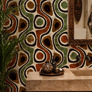 May include: Bathroom interior featuring a patterned wallpaper in brown, green, and black. A wooden vanity with a stone countertop holds decorative items. A mirror and a potted plant are also visible.