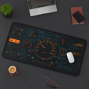 May include: A rectangular desk mat featuring a dark, high-tech digital dashboard graphic with orange illuminated gauges, a central speedometer, lap timers, and performance graphs. The design mimics a modern race car cockpit interface.