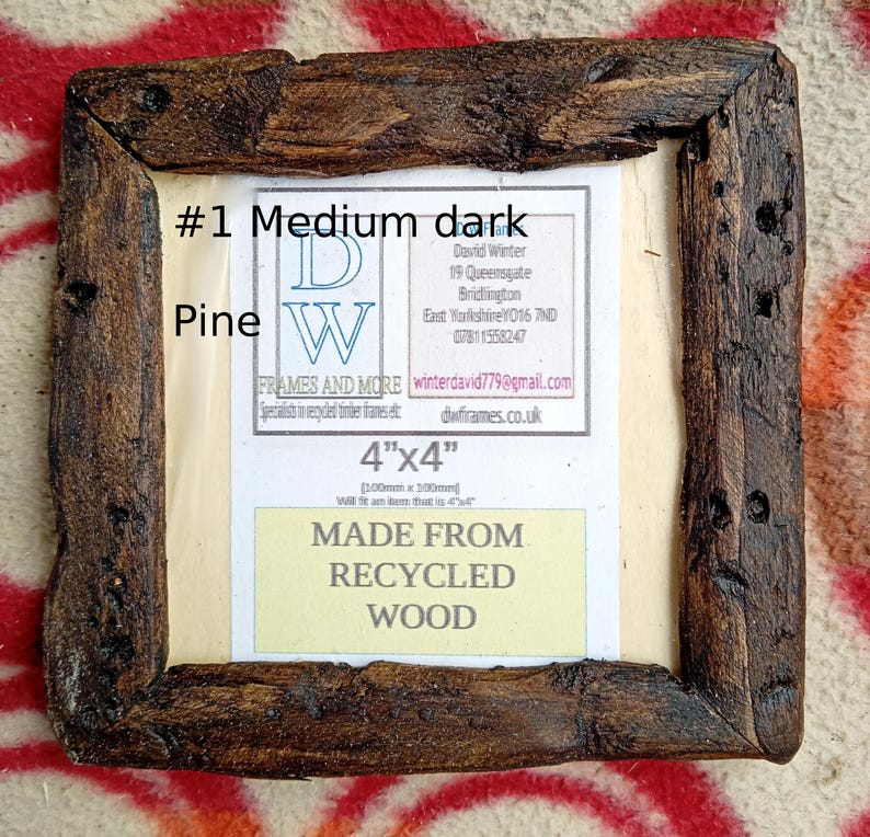 May include: A square picture frame crafted from dark, textured recycled pine wood. The center insert displays the text #1 Medium dark Pine, DW FRAMES AND MORE, 4"x4", [100mm x 100mm], and MADE FROM RECYCLED WOOD, along with contact details for David Winter.