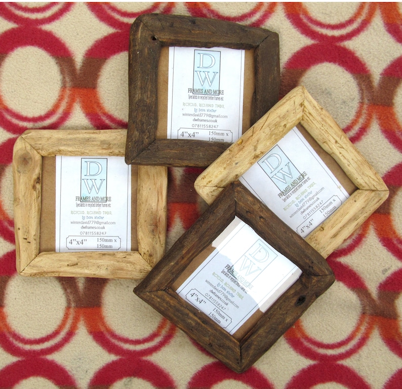 May include: Four square picture frames made of reclaimed wood in varying shades of dark and light brown. Each frame contains a white insert with the text DW FRAMES AND MORE, 4"x4", and 150mm x 150mm. The frames have a rustic, textured finish.