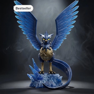 May include: A blue and gold figurine of a bird-like creature with outstretched wings, perched on a translucent blue ice formation. The figurine has yellow eyes and a long, curved tail. The word "Bestseller" is in a white oval in the upper left corner.