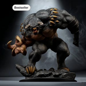 May include: A detailed statue of a monstrous creature with a muscular build, horns, and sharp claws. The figure is primarily dark gray with tan and gold accents. The word "Bestseller" is in a white oval in the upper left corner. The statue is on a rocky base.