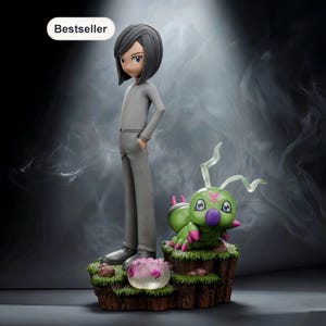 May include: A detailed figurine featuring a character in a gray suit, standing next to a green caterpillar-like creature with pink accents. The base includes a pink, glowing flower and a grassy terrain. The word "Bestseller" is in a white oval.