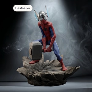 May include: A figurine of Spider-Man in a red and blue suit, holding a hammer and wearing a silver helmet with wings. The figurine is posed on a rocky base, with a "Bestseller" label in the corner.