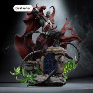May include: A detailed statue of the comic book character Spawn, in a dynamic pose atop a stone structure. The figure is clad in a black and red costume with a flowing red cape. Green, glowing energy and a metal chain add to the dramatic effect. The word "Bestseller" is in the top left corner.