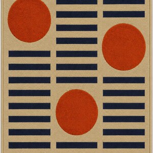 May include: A rectangular area rug featuring a beige background with a repeating pattern of horizontal dark navy blue stripes. Three solid orange circles are positioned across the rug, with two circles on the left and right sides and one circle centered lower down.