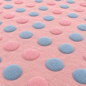 May include: A soft, textured fabric featuring a repeating pattern of raised, circular polka dots. The background is a solid light pink, while the evenly spaced, plush circular dots alternate between a soft light blue and a matching light pink.