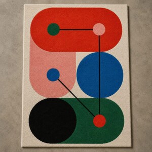 May include: A rectangular area rug featuring a cream background with a geometric pattern of overlapping shapes in red, pink, blue, green, and black. Thin black lines connect small solid circles of various colors across the rug surface.