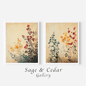 Könnte beinhalten: Zwei gerahmte Wandbilder mit botanischen Illustrationen von Wildblumen in Rot-, Orange- und Dunkelgrüntönen auf einem strukturierten beigen Hintergrund. Der Text "Sage & Cedar Gallery" ist in Schwarz unter den beiden rechteckigen Rahmen gedruckt.