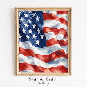 Könnte beinhalten: Ein gerahmtes Aquarellbild der amerikanischen Flagge mit einem blauen Feld mit weißen Sternen und abwechselnden roten und weißen horizontalen Streifen. Das Design hat ein fließendes, wellenförmiges Aussehen mit einem Holzrahmen.