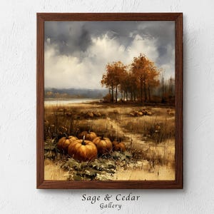 Könnte beinhalten: Ein gerahmtes Landschaftsgemälde mit einem Feld voller orangefarbener Kürbisse im Vordergrund, einem Pfad, der zu einer Gruppe herbstlicher Bäume führt, und einem bewölkten Himmel. Der Text "Sage & Cedar Gallery" steht unten am Rahmen.