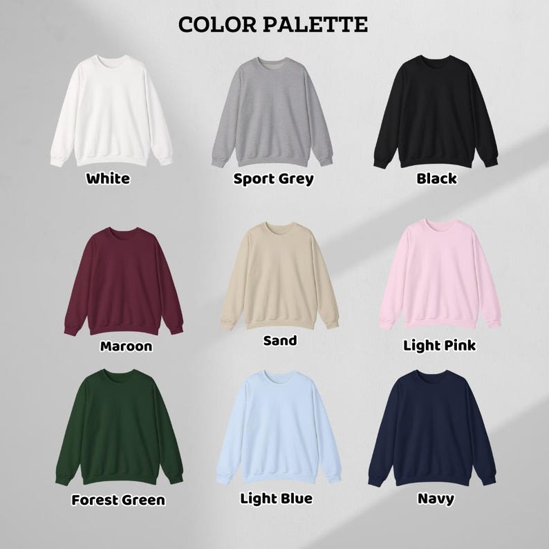 May include: A color palette showcasing nine crewneck sweatshirts in various colors. The colors include white, sport grey, black, maroon, sand, light pink, forest green, light blue, and navy. The text "COLOR PALETTE" is at the top.