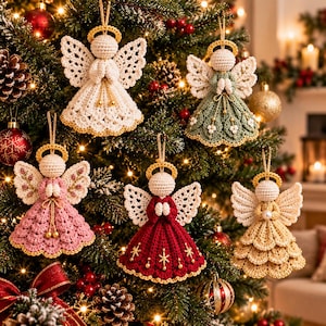 May include: Five crocheted angel ornaments hanging on a Christmas tree. Each angel features a round head, a gold halo, and intricate lace-like wings. The dresses are white, sage green, dusty pink, deep red with gold stars, and beige.