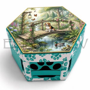 May include: A hexagonal box with a white and teal paw print pattern on the sides and a black paw print cutout on the front. The lid features a detailed illustration of a beagle sitting on a wooden bridge over a stream with ducks and flowers.