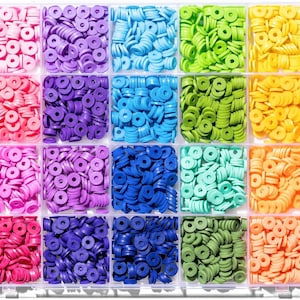 May include: A clear plastic storage container with twenty-four rectangular compartments, each filled with small, flat, circular clay beads in a variety of solid colours including white, grey, brown, black, pink, purple, blue, green, yellow, orange, and red.