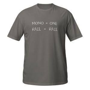 May include: A charcoal grey short-sleeved t-shirt featuring white text printed on the chest. The text reads MONO = ONE and RAIL = RAIL in a simple, hand-drawn style font. The shirt has a crew neckline and a standard, straight-cut silhouette.