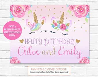 May include: Printable sign with two unicorn faces with gold glitter horns and flowers. The sign says "Happy Birthday Chloe and Emily" in pink and gold glitter letters. The background is a gradient of pink and purple with gold glitter dots.