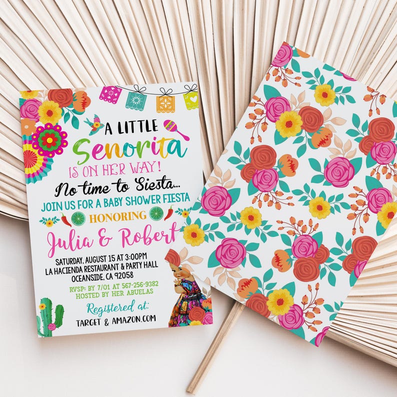 May include: Baby shower invitation with the text "A Little Senorita Is On Her Way!" in turquoise and pink. The invitation features colorful floral and decorative elements, including a cactus and maracas. The invitation is for Julia & Robert.