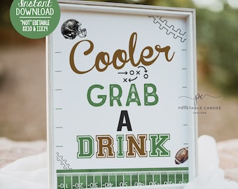 May include: A white framed sign with green and brown text that reads "Cooler Grab A Drink". The sign has a football helmet, football, and football field graphics. The text "Printable Candee Designs" is in the bottom right corner.