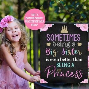 May include: A black chalkboard sign with pink and blue floral accents. The sign reads "Sometimes being a Big Sister is even better than being a Princess".