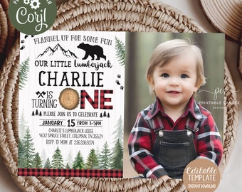 May include: A printable invitation for a first birthday party with a lumberjack theme. The invitation features a red and black buffalo plaid pattern, a cartoon bear, and a photo of a baby boy wearing a red and black plaid shirt. The text on the invitation reads "Flannel up for some fun, our little lumberjack Charlie is turning one. Please join us to celebrate January 15 from 3-5pm. Charlie's Lumberjack Lodge, 4632 Spruce Street, Coleman, TN 35524. RSVP to Mom at 236-336-9374."