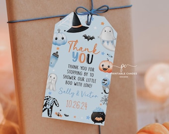 May include: Blue and orange Halloween baby shower favour tag with a ghost, witch, and pumpkin. The tag says "Thank You" and "Thank you for stopping by to shower our little boo with love! Sally & Victor 10.26.24"