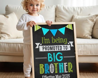 May include: A chalkboard sign with a white frame announcing a child is being promoted to big brother. The sign has a blue and green color scheme with a banner of flags at the top. The text on the sign reads "I'm being promoted to big brother. Effective May 2025."
