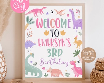 May include: A printable welcome sign for a 3rd birthday party with a dinosaur theme. The sign features a pink, green, purple, and yellow color scheme with dinosaurs and flowers. The text on the sign reads "Welcome to Emersyn's 3rd Birthday".