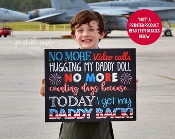 May include: A child holds a black chalkboard sign with the text "NO MORE Video calls HUGGING MY DADDY DOLL *NO MORE* counting days because... TODAY I get my DADDY BACK!" The sign has red, white, and blue stars and fireworks.