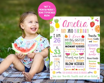 May include: A colorful printable birthday sign for a girl named Amelia turning two. The sign features a watermelon, a pineapple, a strawberry, a kiwi, and a lemon. The sign says "Amelia My 2nd Birthday" and includes details about the child, such as her weight, height, and favorite things.